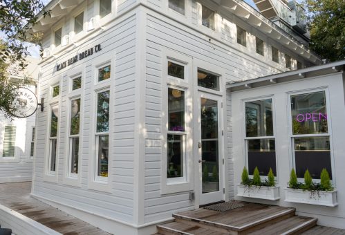 Exterior of Black Bear Bread Co., a white modern bakery building with large windows and signage.