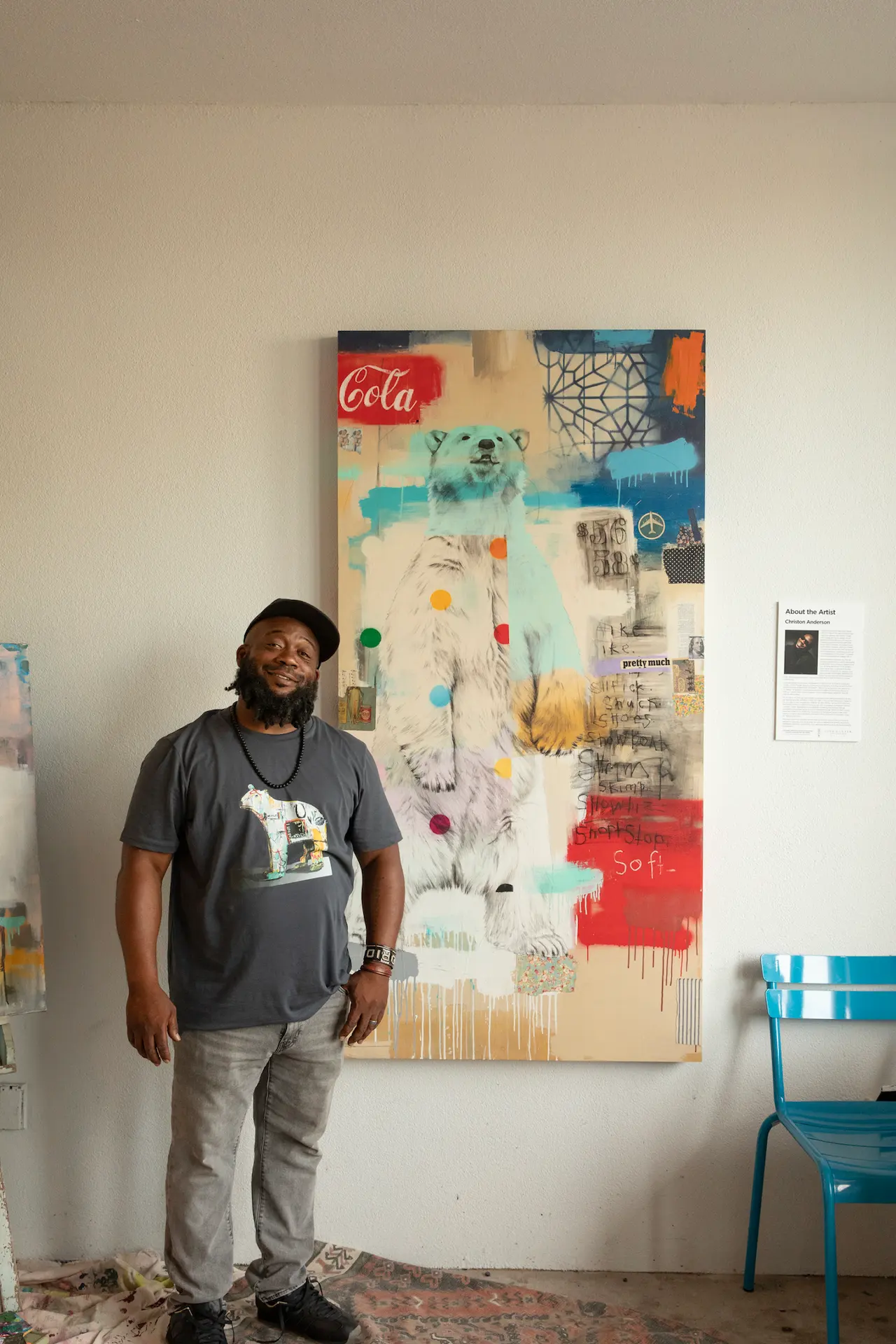 Person standing beside colorful polar bear painting in modern room, wearing matching polar bear print t-shirt.