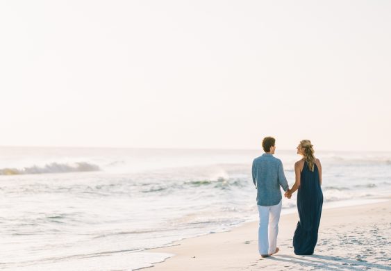 A couple strolling along Seaside beach