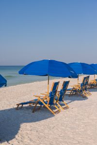 Reserved beach chairs and umbrella setup by Cabana Man at Seaside, Florida