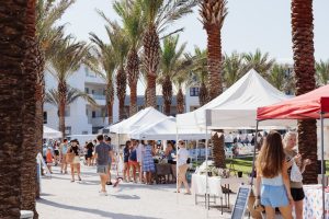 45 facts about seaside shoppers browsing seaside farmers market under palm trees